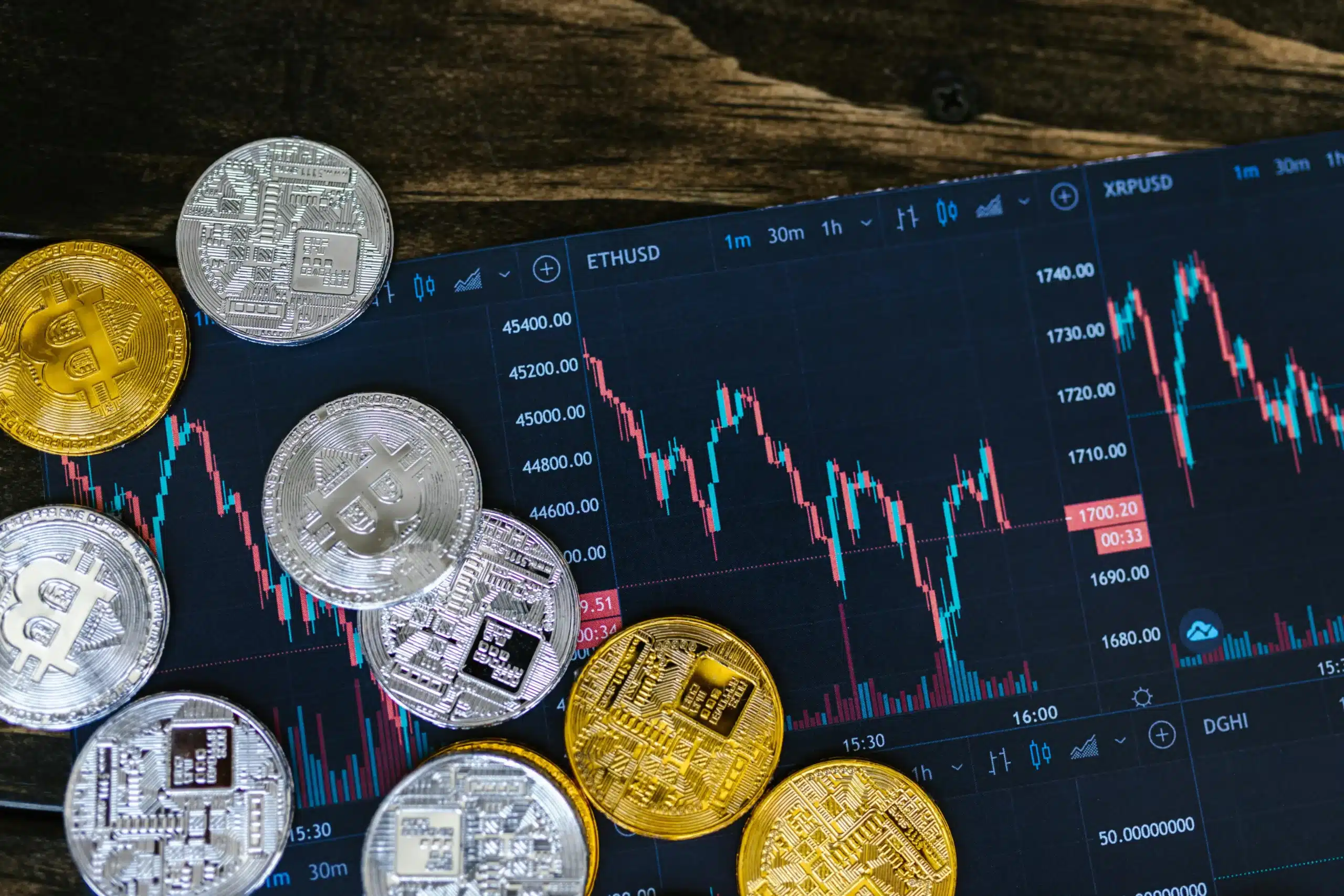 Des pièces de cryptomonnaie (Bitcoin, Ethereum) disposées sur un graphique boursier montrant l'évolution du marché, symbolisant l'impact de l'intelligence artificielle sur l'analyse et les transactions de crypto-actifs.
