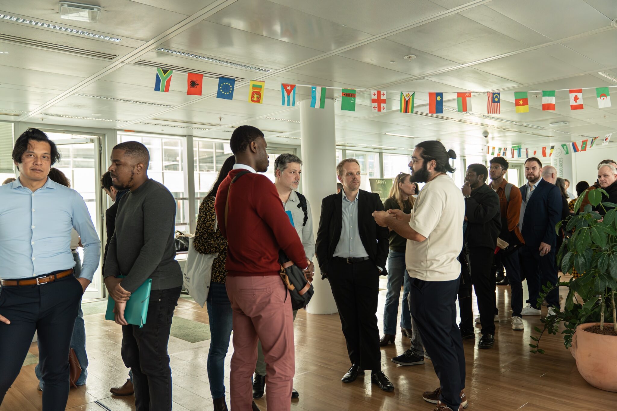 Four professionals celebrating a successful collaboration around architectural plans and project materials